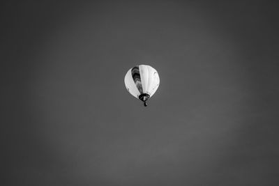 Low angle view of person paragliding against clear sky