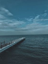 Pier over sea against sky