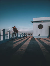 Man standing by built structure against sky