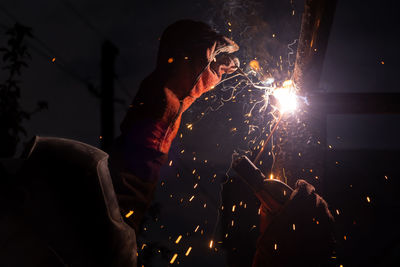 Welding steel with sparks. welding closeup. welder with protective mask welding