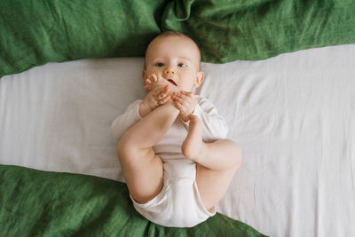 Portrait of cute baby boy sleeping on bed at home