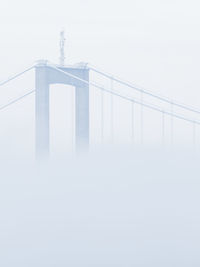 Low angle view of suspension bridge against clear sky