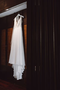 Low angle view of wedding dress hanging on closet