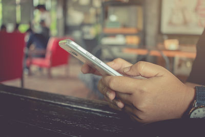 Close-up of man using mobile phone