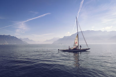 Sailboat sailing on sea against sky