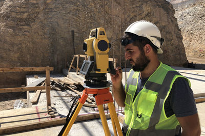 Portrait of young man standing at construction site