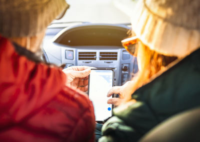 Rear view of people sitting in car