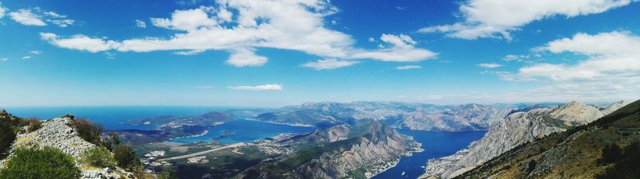 Panoramic view of sea and mountains against sky