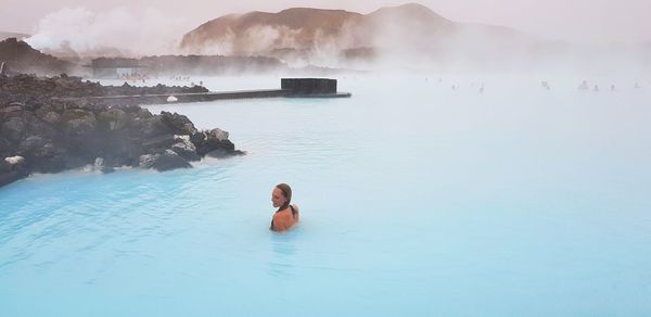 High angle view of woman enjoying in hot spring