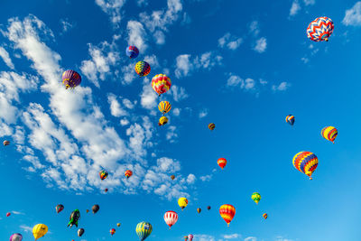 Low angle view of hot air balloons flying in sky