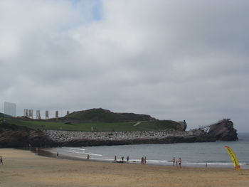 People on beach against sky