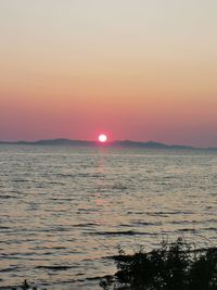 Scenic view of sea against romantic sky at sunset