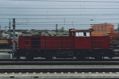 Train on railroad tracks against sky during winter