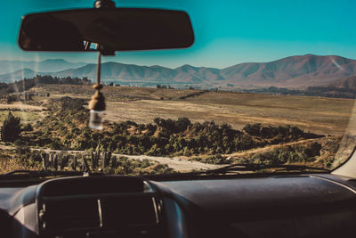 Landscape seen through car windshield