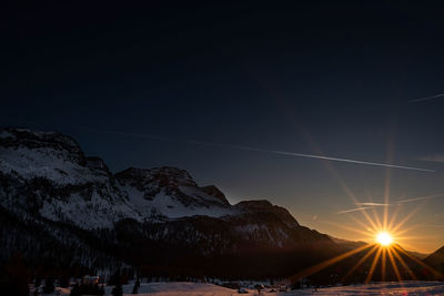 Scenic view of snowcapped mountains against sky during sunset