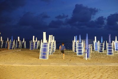 Man on beach by sea against sky