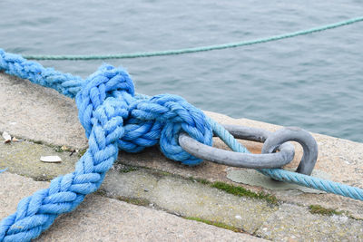 Close-up of rope tied at pier