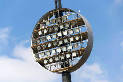 Low angle view of floodlights against sky