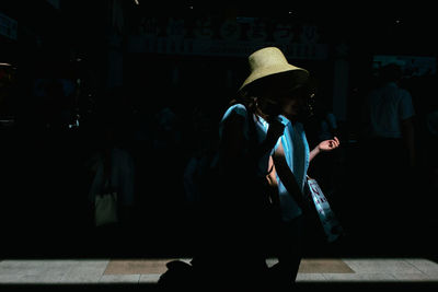 Man and woman standing in city at night