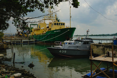 Fishing boats moored at harbor