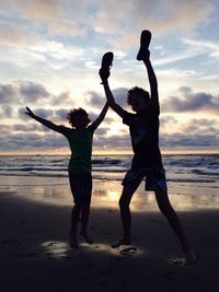 People on beach at sunset