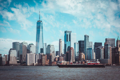 Modern buildings in city against cloudy sky