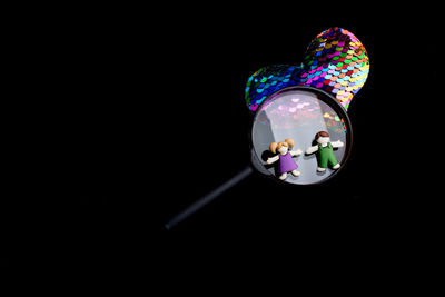 Close-up of illuminated lighting equipment against black background