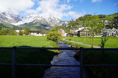 Scenic view of landscape and buildings against sky