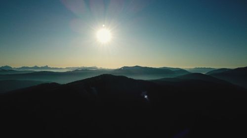 Scenic view of silhouette mountains against sky during sunset