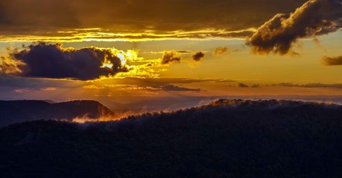 Scenic view of dramatic sky during sunset