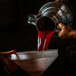 Midsection of man pouring drink in glass