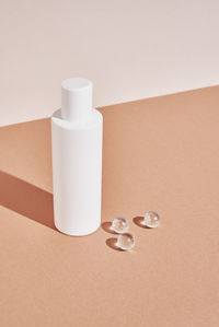 Beaty product package. cosmetic bottle on pastel beige background. cosmetics mock up