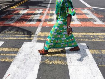 Low section of woman standing on footpath