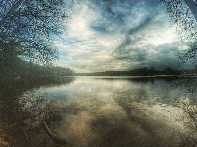 water, tranquil scene, tranquility, sky, scenics, lake, beauty in nature, reflection, cloud - sky, tree, nature, cloudy, idyllic, cloud, calm, bare tree, river, non-urban scene, outdoors, no people