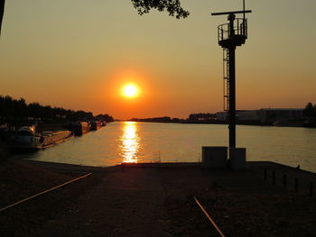 Scenic view of silhouette tower against sky during sunset