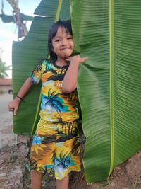 Portrait of smiling girl standing outdoors