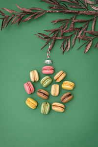 Abstract different macaroons christmas ball hanging in tree