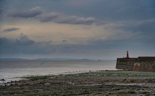Scenic view of sea and buildings against sky