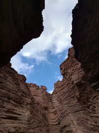 Low angle view of rock formations against sky