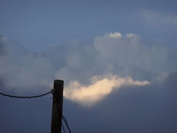 Low angle view of power lines against blue sky