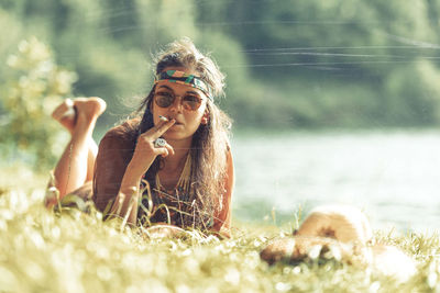 Portrait of young woman wearing sunglasses outdoors