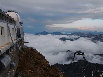 Abandoned vehicle on mountain against sky