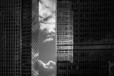 Low angle view of modern building against cloudy sky