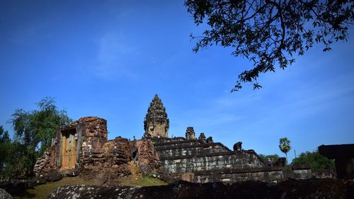 Low angle view of old building against blue sky