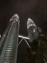 Low angle view of illuminated buildings against sky at night