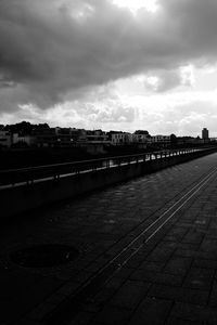 Railroad tracks in city against sky