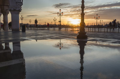 Reflection of building in puddle on street