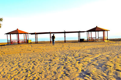 Gazebo on beach against sky