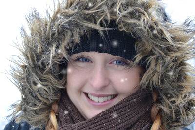 Portrait of a smiling young woman in snow