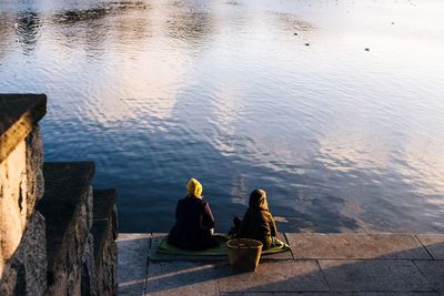 Women sitting by river